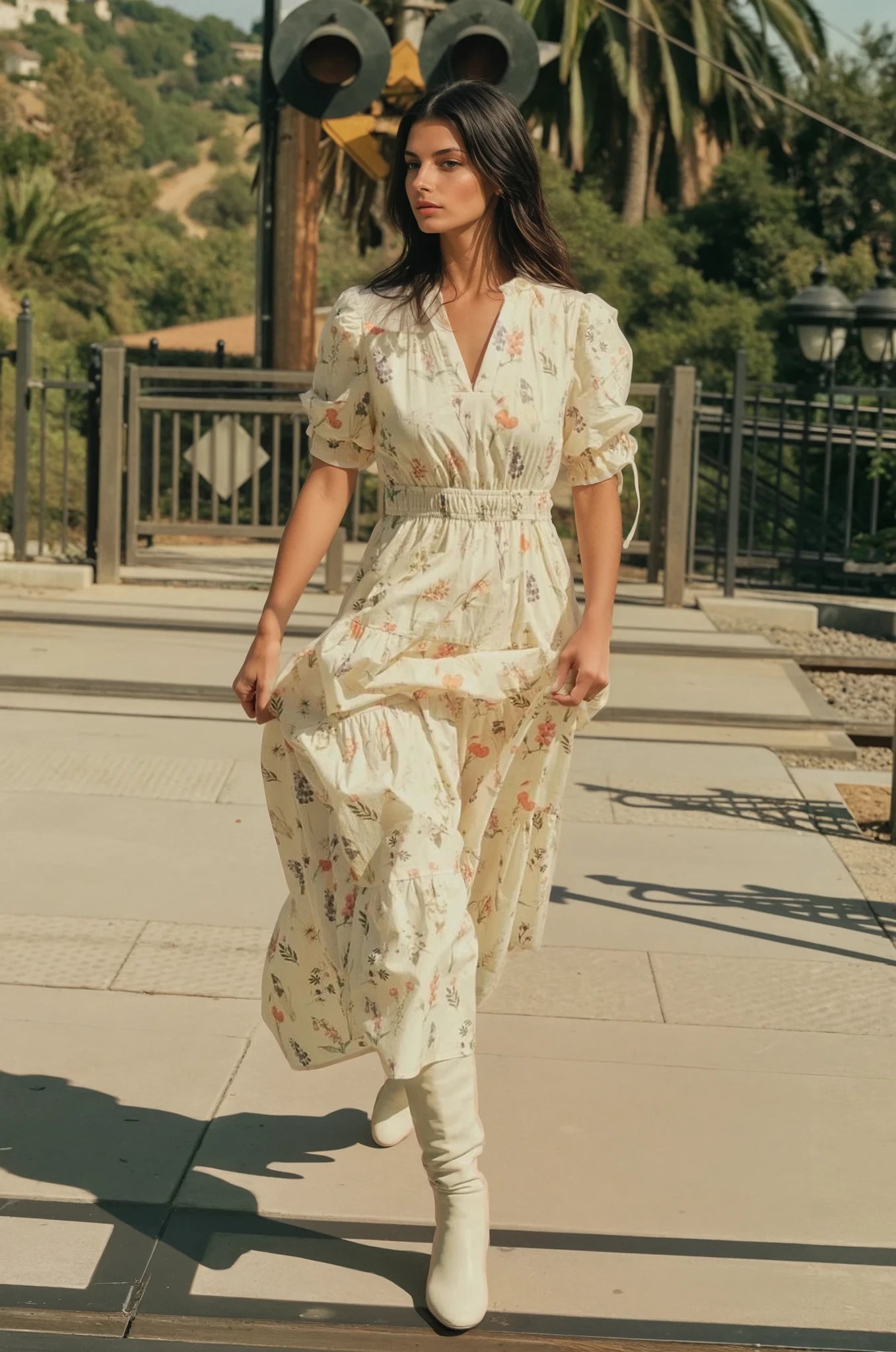 Woman in a floral dress walking outdoors on a sunny day.